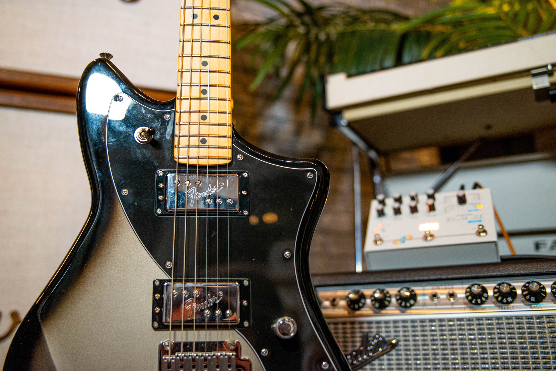 Photo of a Fender Meteora guitar next to an amplifier