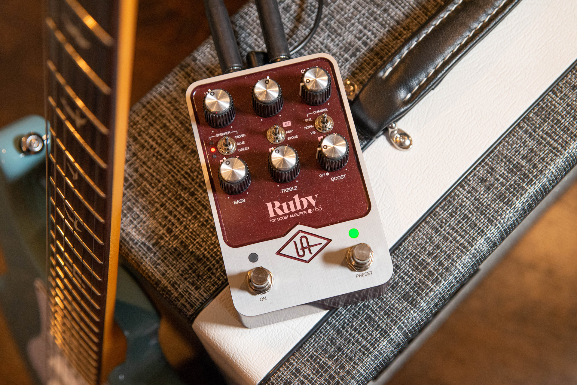 Photo of a Universal Audio Ruby pedal sitting on a combo amplifier
